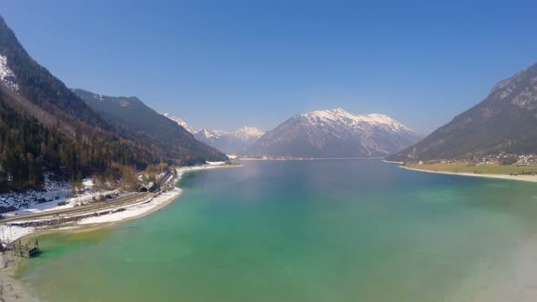 Panorama of Deep Blue Lake at Snowy Mountains Bottom, Mirror-Like Water Surface alt