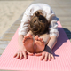 Woman doing yoga poses on beach Stock Photo by molenira