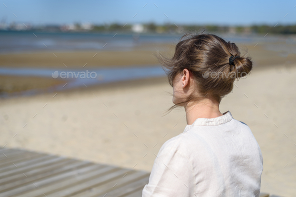 Woman doing yoga poses on beach Stock Photo by molenira
