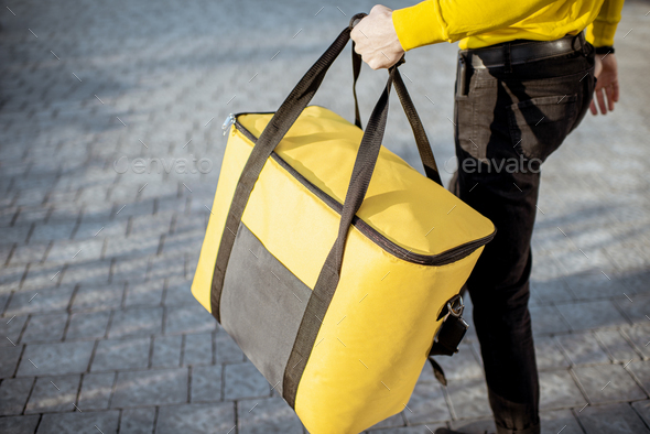 Courier carrying thermal bag, delivering food