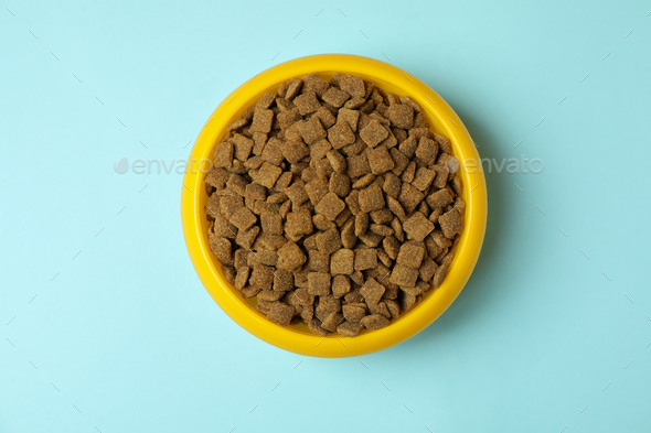 Download Pet Bowl With Feed On Blue Background Stock Photo By Atlascomposer