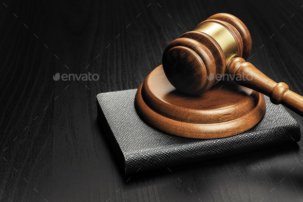Wooden mallet on black wooden table close up