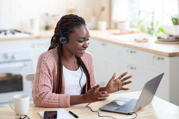 Online Tutoring. Black Female Teacher In Headset Having Virtual Lesson With Students