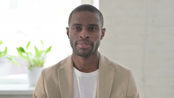 Portrait of Serious African Man Looking at the Camera alt