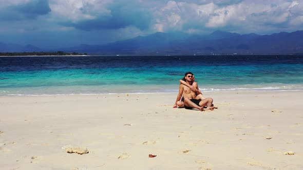 Beautiful Lady and Man on Romantic Honeymoon Live the Dream on Beach on Paradise White Sand alt