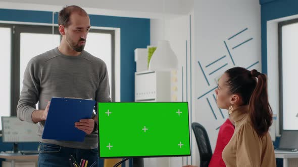 Workmates Using Computer with Green Screen on Display alt