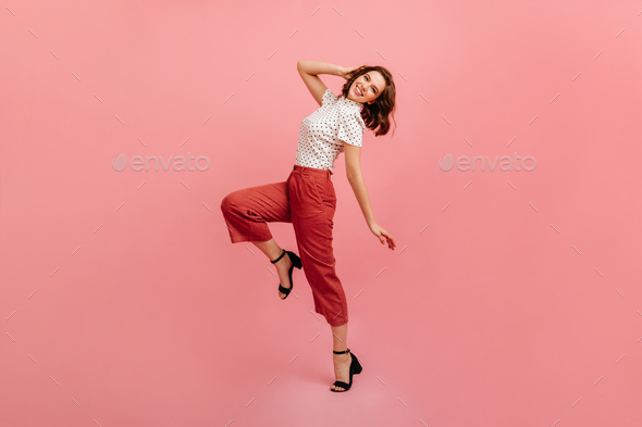Inspired slim girl dancing on pink background. Studio shot of graceful trendy woman in black shoes. - Stock Photo - Images