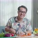 Asian Man Smiling To Camera While Cook Healthy Food At Home - VideoHive Item for Sale