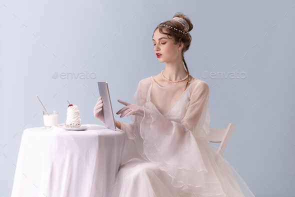 Young woman in art action isolated on white background. Retro style, comparison of eras concept - Stock Photo - Images