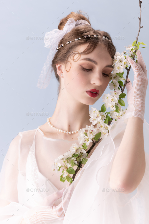 Young woman in art action isolated on white background. Retro style, comparison of eras concept - Stock Photo - Images