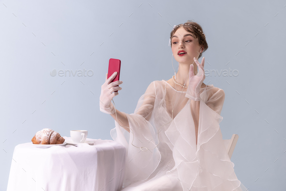 Young woman in art action isolated on white background. Retro style, comparison of eras concept - Stock Photo - Images