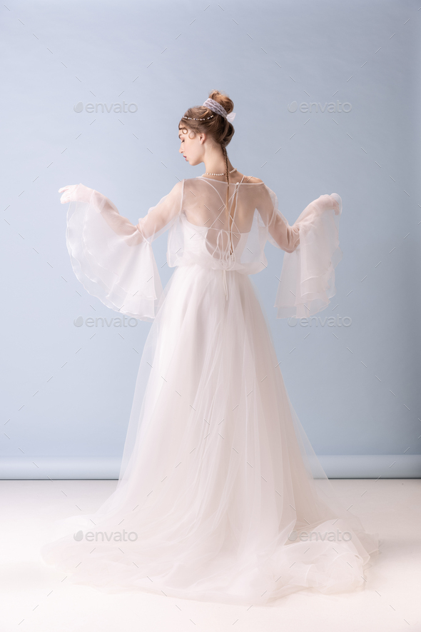 Young woman in art action isolated on white background. Retro style, comparison of eras concept - Stock Photo - Images