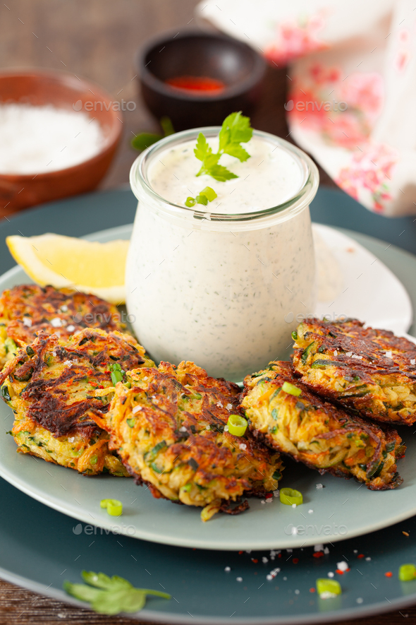 Zucchini fritters with sour cream - Stock Photo - Images