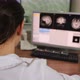 Radiologist Looking at Monitors with Brain MRI Image Results in Control Room - VideoHive Item for Sale
