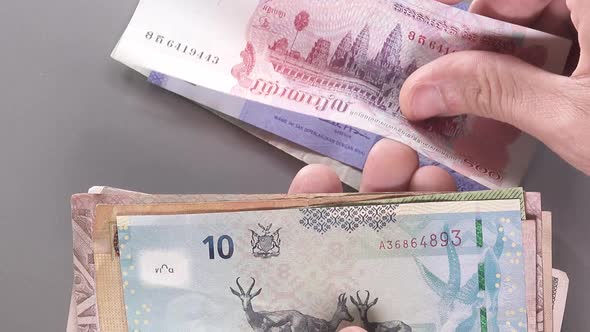 Throwing Bills From Different Countries To Glass