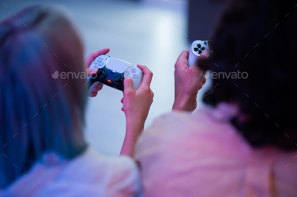 Girl with next gen controller in her hands playing games at home - Stock Photo - Images
