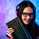 Young teen gamer wearing glasses standing posing with computer gaming equipment - PhotoDune Item for Sale