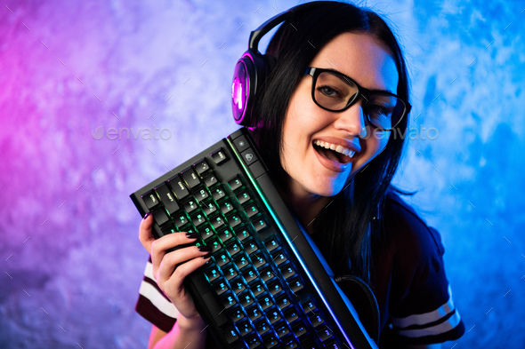 Happy young man playing and winning online game on computer. Back view of  gamer with video console gamepad controller. Competitive gaming, electronic  sports, technology, gaming, entertainment concept., Stock image