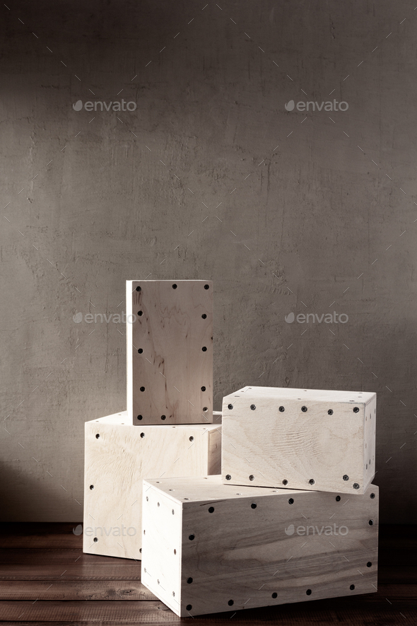 Wooden cube or plywood box block near wall background texture. Abstract construction concept