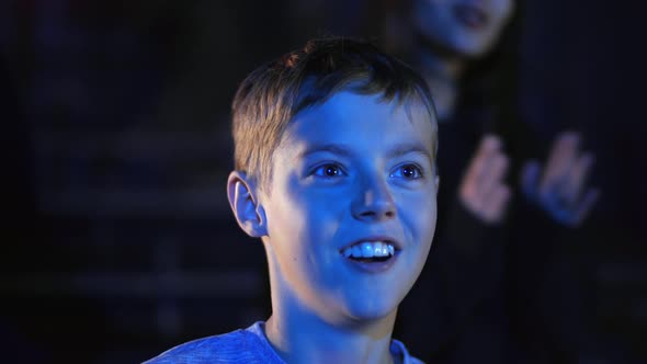 Cheerful Caucasian Kid Clap Hands with Impressions and Smile in Circus alt