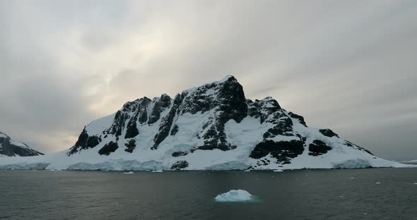 WS Lemaire Channel with snow covered mountain at sunset / Antarctica