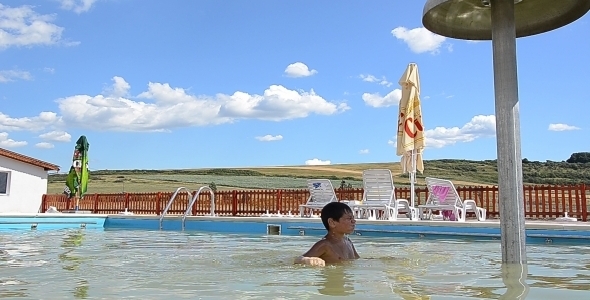 Kid Swimming On Sunny Day