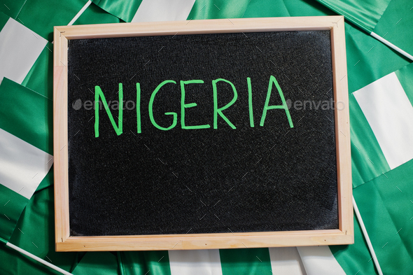 Happy independence day of Nigeria. Text on board with nigerian flags. - Stock Photo - Images