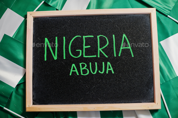 Happy independence day of Nigeria, Abuja. Text on board with nigerian flags. - Stock Photo - Images
