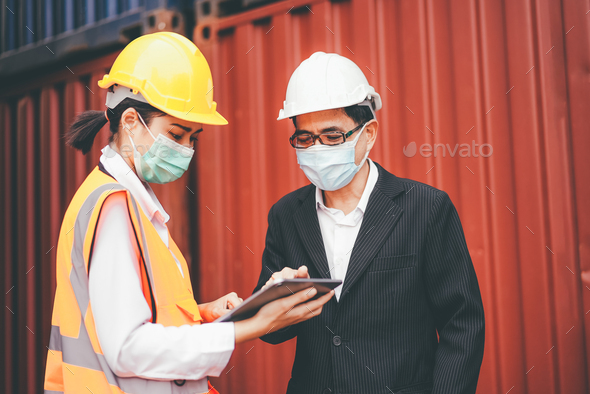 Asian logistic foreman wearing protective mask working with female worker