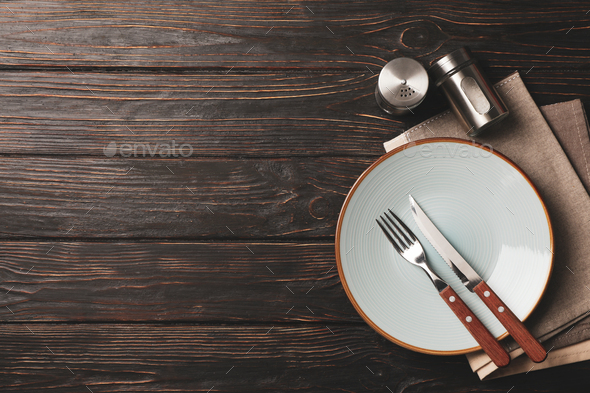 Table setting with spices and towel on wooden background, top view Stock  Photo by AtlasComposer