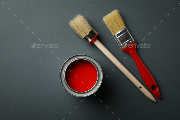 Can of red paint and brushes on black background, top view Stock Photo by  AtlasComposer