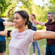Mixed Race Woman Exercising In Park With Mature Friends Stock