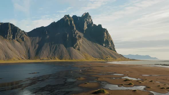 Aerial Drone Footage of Vestrahorn Mountain and Stokksnes Beach in Low Tide alt