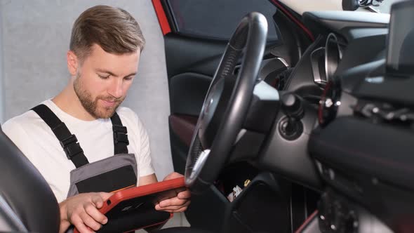 The Mechanic Maintains the Vehicle with the Help of Diagnostic Computer Equipment  Modern Equipment alt