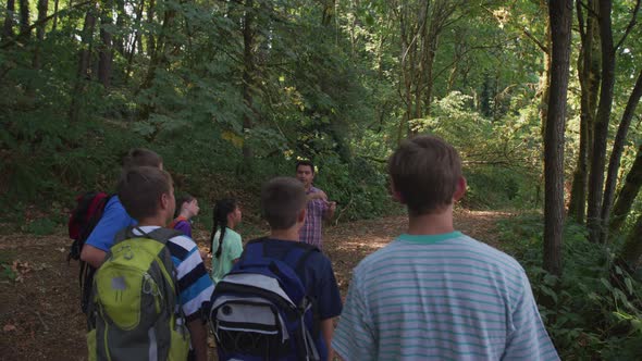 Kids at summer camp going on a nature hike