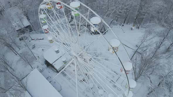 Ferris Wheel on Top of Mount Akhun During a Snowfall alt