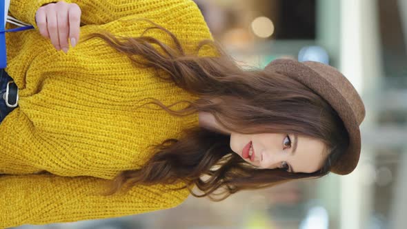 Vertical Screen Stylish Woman Looking at Shop Windows alt