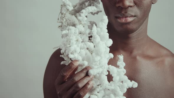 Shirtless Man With Fluffy Branch alt