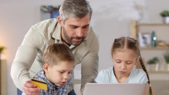 Family Using Credit Card for Shopping alt
