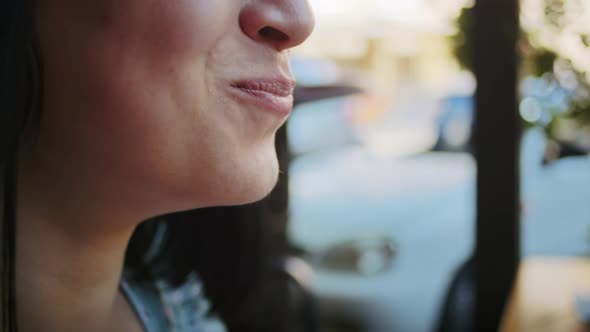 a Happy Woman Enjoys Delicious Food in a Street Cafe Rejoices in This Taste and Smell alt