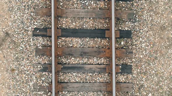 Flying Over Old Rails with Wooden Sleepers Closeup alt