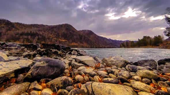 Time Lapse Shot of a River Near Mountain Forest. Huge Rocks and Fast Clouds Movenings alt