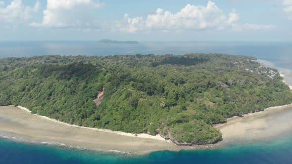 Aerial: flying over tropical Ai island white sand beach Banda Islands Maluku Ind alt