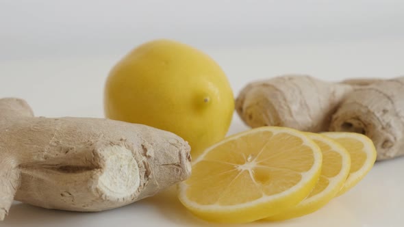 Organic  Zingiber officinale rhizome and citrus slow tilt 4K 2160p 30fps UltraHD footage - Lemon sli alt