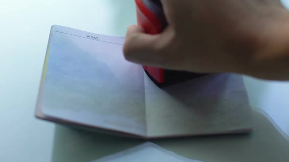 Visa Canceled, Customs Officer Hand Stamping Seal in Passport, Travelling Abroad alt