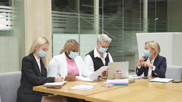 Busy Colleagues in Masks in the Office Wearing Formal Clothes During Pandemic Covid19 alt