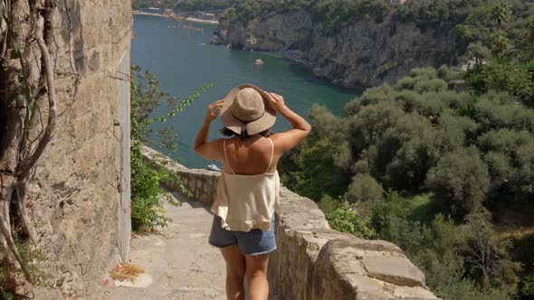 Young Female Tourist Admires the Beautiful View of the Sea and Mountains alt