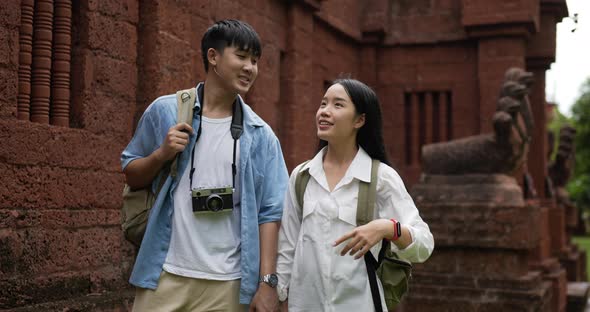 Couple hand together while visiting at ancient temple alt