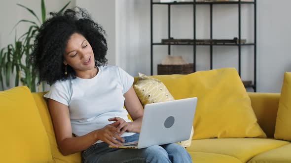 Portrait of a Young African American Woman Talking on a Video Call on Portable Laptop alt