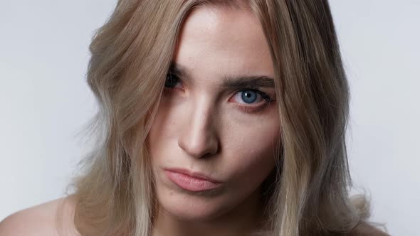 Emotion Attractive Woman Looking at Camera Blonde Angry Closeup White Background